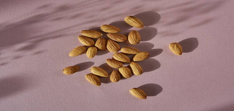 Amandelen zijn gezond en daarom een geweldige toevoeging aan je dieet. Afbeeldingen van een handvol amandelen.